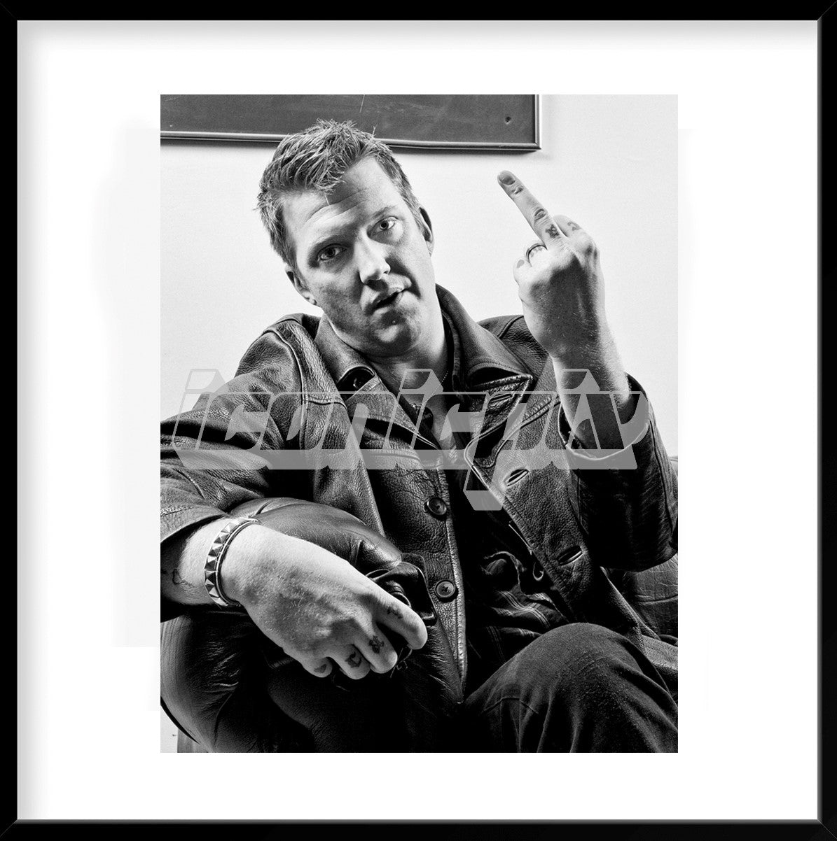 QUEENS OF THE STONE AGE - vocalist and guitarist Josh Homme in a classic pose during a photosession for Kerrang! Magazine in London in 2007. Photo: © Ashley Maile / IconicPix