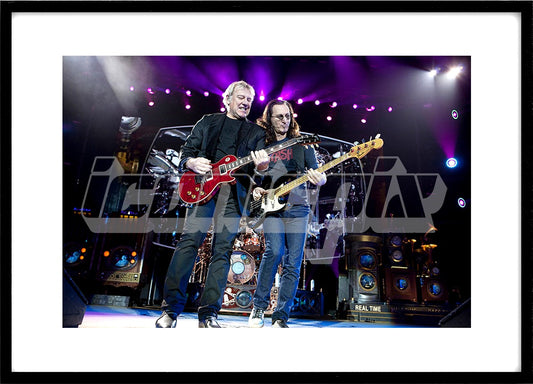 Rush - guitarist Alex Lifeson and bass player vocalist Geddy Lee - performing live on the Time Machine Tour at the O2 Arena in London UK - May 25, 2011.  Photo: © Ashley Maile/IconicPix